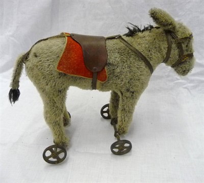 Lot 1025 - Circa 1910 Possibly Steiff Donkey On Wheels with a deep grey mohair, black mane and tail, black...