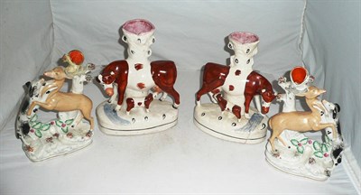 Lot 8 - A pair of Staffordshire cow spill vases (a.f.) and another pair (4)