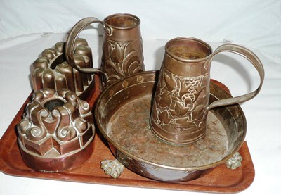 Lot 24 - Two copper jelly moulds, two Arts and Crafts measures and a footed bowl