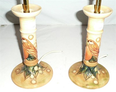 Lot 31 - A pair of Moorcroft Finches pattern candlestick lamp bases, (seconds)