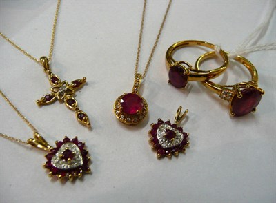 Lot 81 - Three 9ct gold ruby and diamond pendants on chains, a 9ct gold pendant set with a glass filled ruby