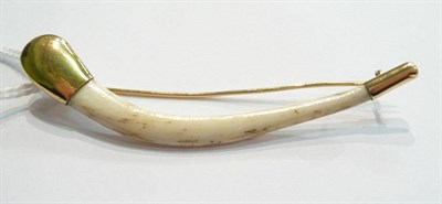 Lot 110 - A gold metal mounted tiger's clavicle bone, circa 1910, with simple metal tips and pin...