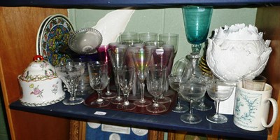 Lot 130 - A quantity of ceramics on a shelf including Isnik dishes, blue and other glassware, a white...