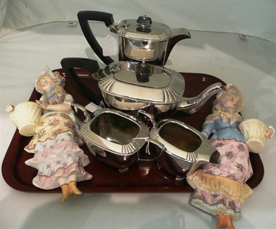 Lot 152 - A four piece electroplate tea set and a pair of wall hanging figures (a.f.)