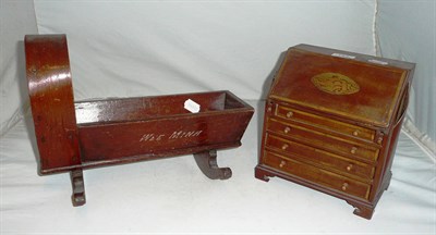 Lot 183 - Miniature inlaid bureau and a dolls cradle inscribed 'Wee Mina' (2)