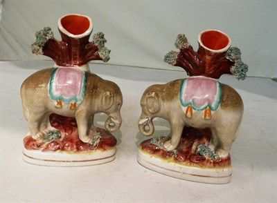 Lot 215 - A pair of small Staffordshire elephant spill vases (2)