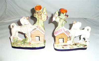 Lot 221 - A pair of Staffordshire spill vases modelled as a dog outside a kennel looking at a bird