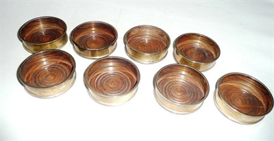 Lot 249 - A set of eight silver coasters