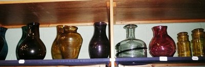 Lot 270 - Two shelves of coloured glass including vases, storage jars, green witches ball etc