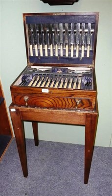 Lot 275 - A cased canteen of cutlery on a stand