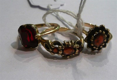 Lot 51 - A 9ct gold garnet ring, a 9ct gold ring and a garnet cluster ring