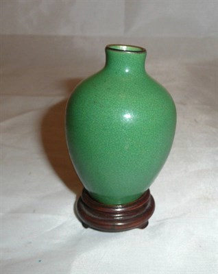 Lot 56 - Chinese apple green monochrome small vase on wood stand, late 19th century