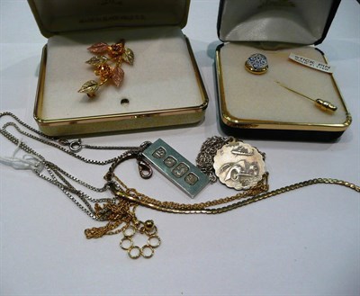 Lot 388 - A silver ingot on chain, a St Christopher pendant on chain, a floral brooch stamped '10K',...