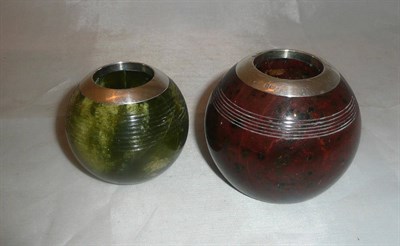 Lot 480 - A red serpentine matchball with silver mount and another green marble example