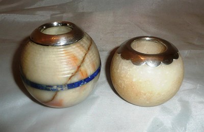 Lot 483 - A cream striated marble matchball banded in lapis lazuli, with silver mount and an alabaster...