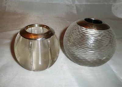 Lot 484 - A facet cut glass matchball with silver mount and a segmented glass example with silver mount