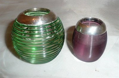 Lot 485 - A small amethyst glass matchball with silver mount and a green trailed glass example