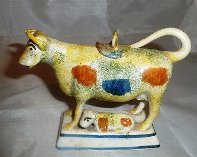 Lot 486 - A Prattware cow creamer with sponged decoration (a.f.)