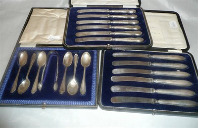 Lot 501 - Two cased sets of six silver handled tea knives and a cased set of silver teaspoons with tongs...