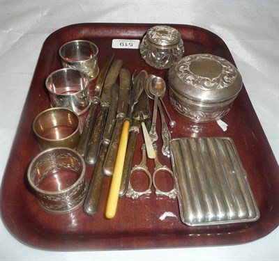 Lot 519 - Embossed silver circular box, four napkin rings, cutlery etc