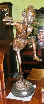 Lot 559 - Reproduction bronzed figure of a Pixie playing a pipe