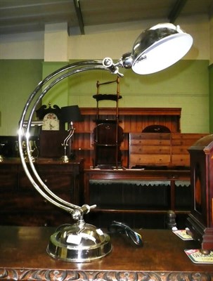 Lot 571 - A white metal desk lamp on a circular base
