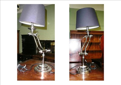 Lot 572 - A pair of white metal lamps