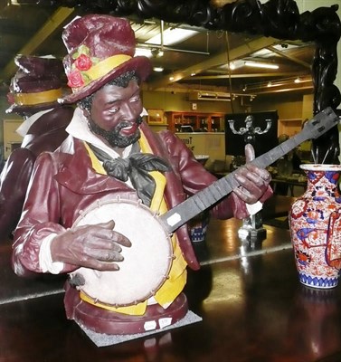 Lot 575 - Plaster figure playing a banjo