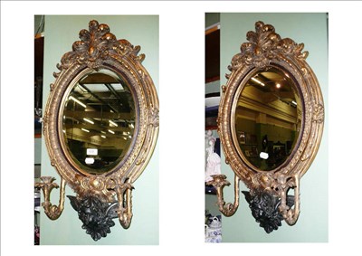 Lot 639 - Pair of sconce wall mirrors mounted with cherubs