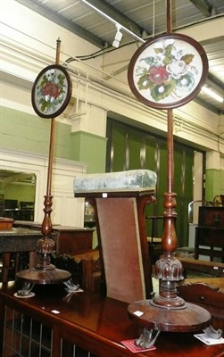 Lot 654 - A pair of Victorian rosewood pole screens
