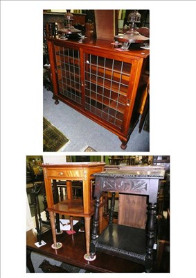 Lot 655 - A teak glazed bookcase, an ebonised oak two tier occasional table, a marble top bedside table and a
