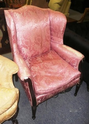 Lot 702 - A 19th century mahogany framed winged back armchair