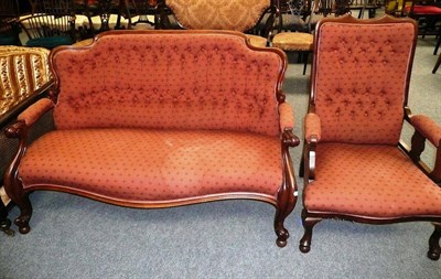 Lot 719 - A Victorian carved mahogany sofa and a mahogany upholstered elbow chair