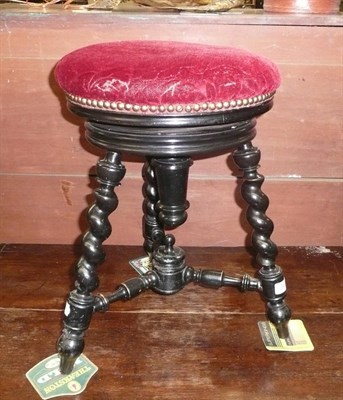 Lot 743 - A Victorian ebonised revolving piano stool on barley twist legs