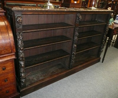 Lot 750 - Carved oak open bookcase