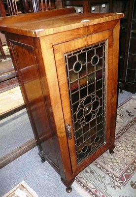 Lot 771 - An Edwardian walnut cabinet with stained glass door