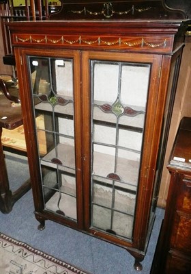 Lot 772 - An Edwardian small mahogany salon cabinet with leaded glazed doors