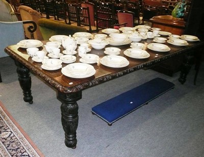 Lot 793 - Late 19th/early 20th century carved oak extending dining table