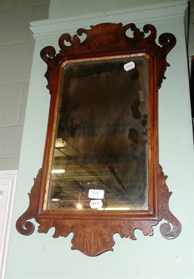 Lot 810 - A walnut fret cut wall mirror