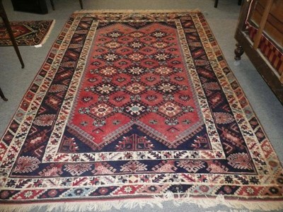 Lot 819 - Yagibedir Carpet West Anatolia The faded raspberry field with three columns of latch hook guls...