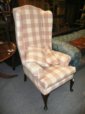 Lot 843 - An oversized wing back chair