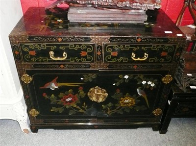 Lot 890 - An oriental black lacquered side cabinet