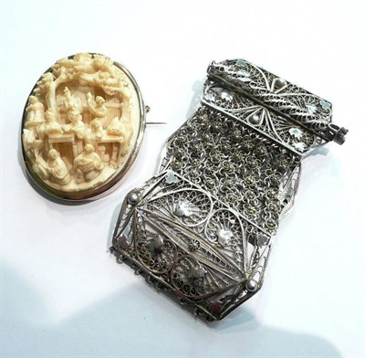 Lot 11 - A Chinese carved ivory brooch in a yellow metal surround and a filigree bracelet