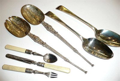 Lot 25 - A pair of silver salad servers, two Georgian serving spoons and a three piece Christening set