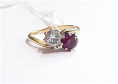 Lot 66 - A diamond and ruby cross over ring