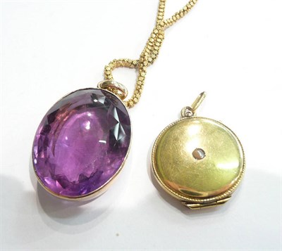 Lot 70 - An amethyst pendant on a granulated chain and a half pearl set circular locket