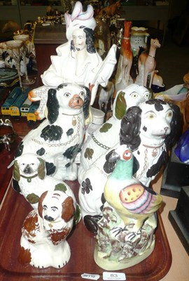 Lot 83 - Three Victorian Staffordshire seated spaniels, two smaller, an exotic bird, and a figure of...