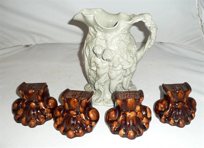 Lot 216 - Four Treacle glazed lions paw furniture feet and a water jug