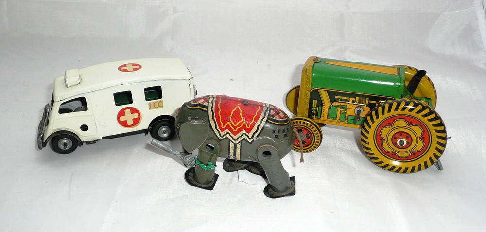 Lot 1114 - Three Clockwork Tinplate Toys - Tri-ang Minic ambulance, Mettoy tractor and Japanese elephant