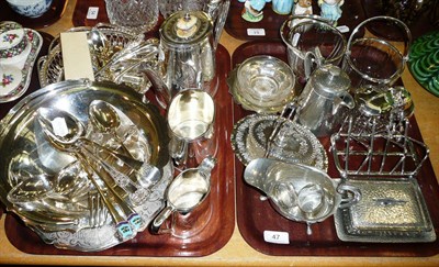 Lot 47 - Assorted silver spoons and a quantity of plated wares on two trays